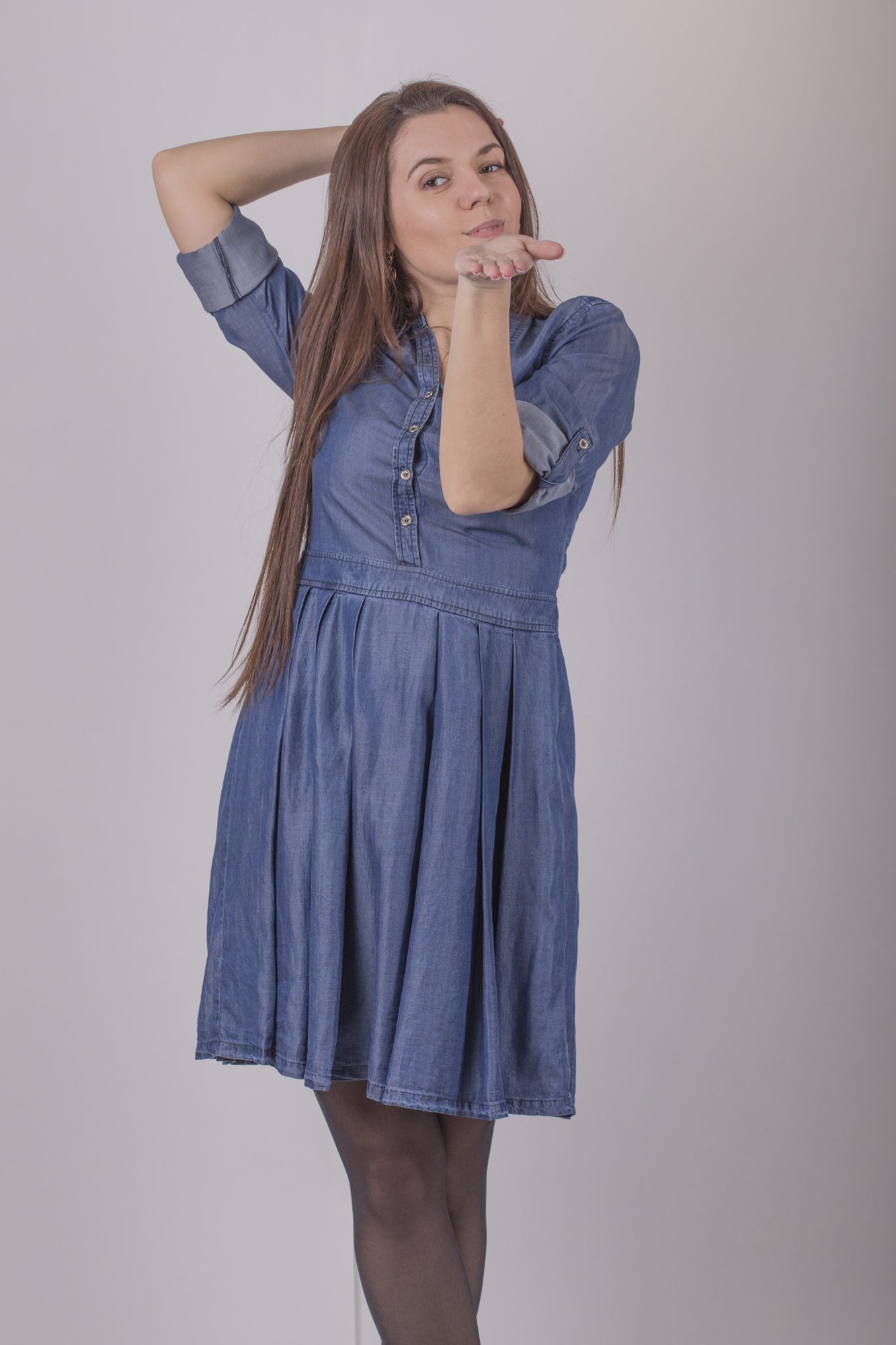Playful full-length portrait in blue dress