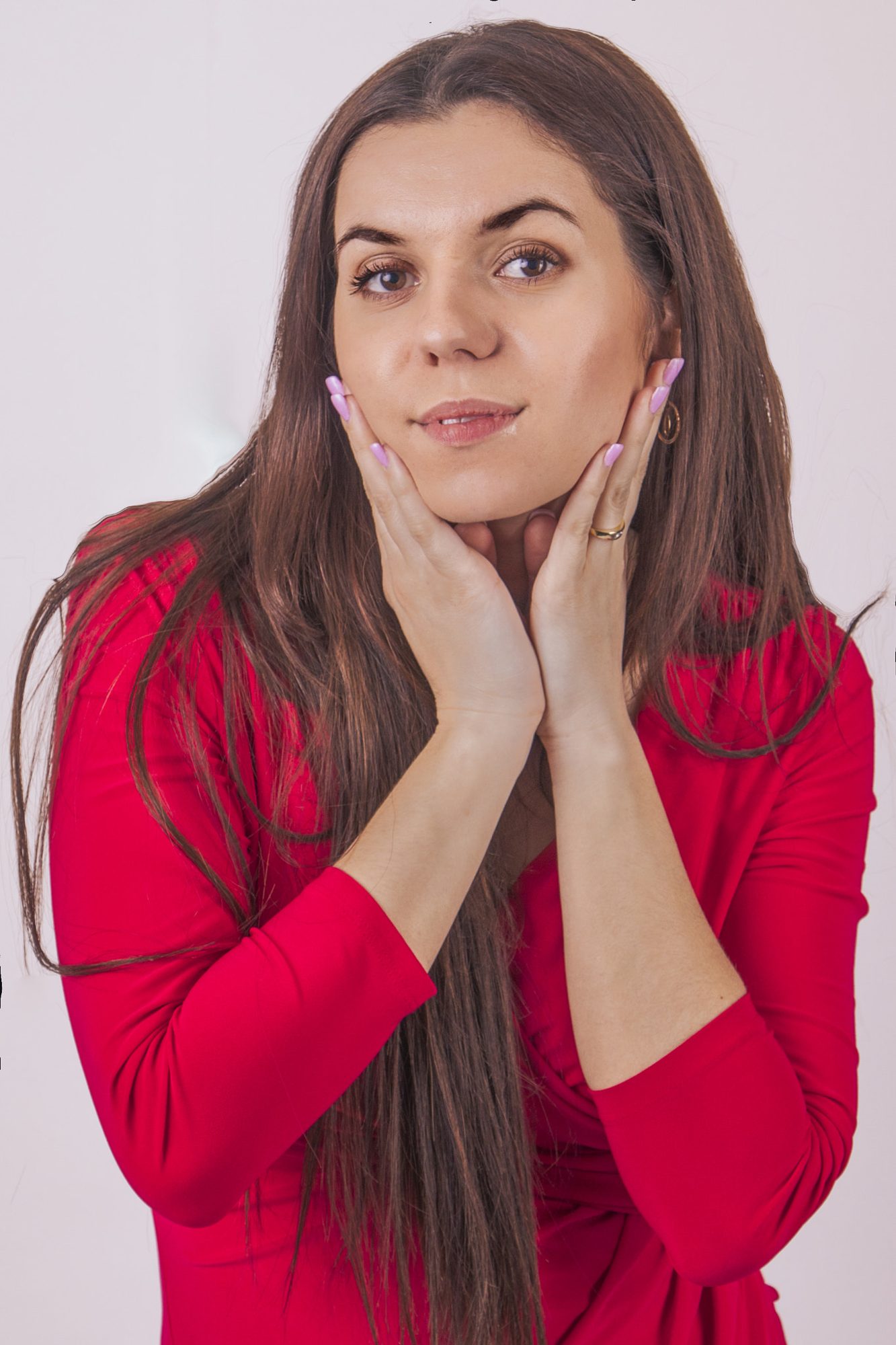 Studio portrait, hands framing face