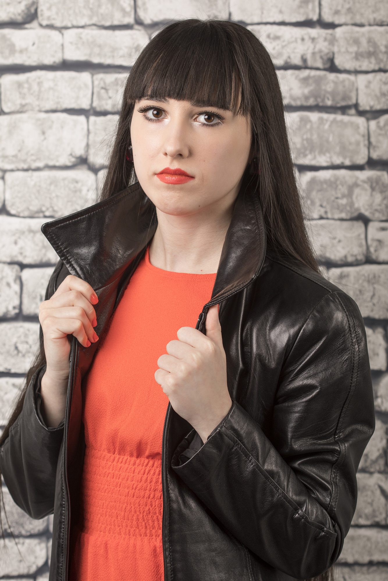 Portrait in orange dress and leather jacket