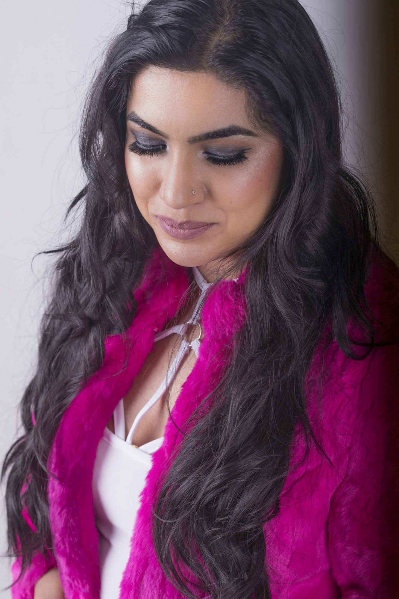 Portrait in pink coat with dark hair