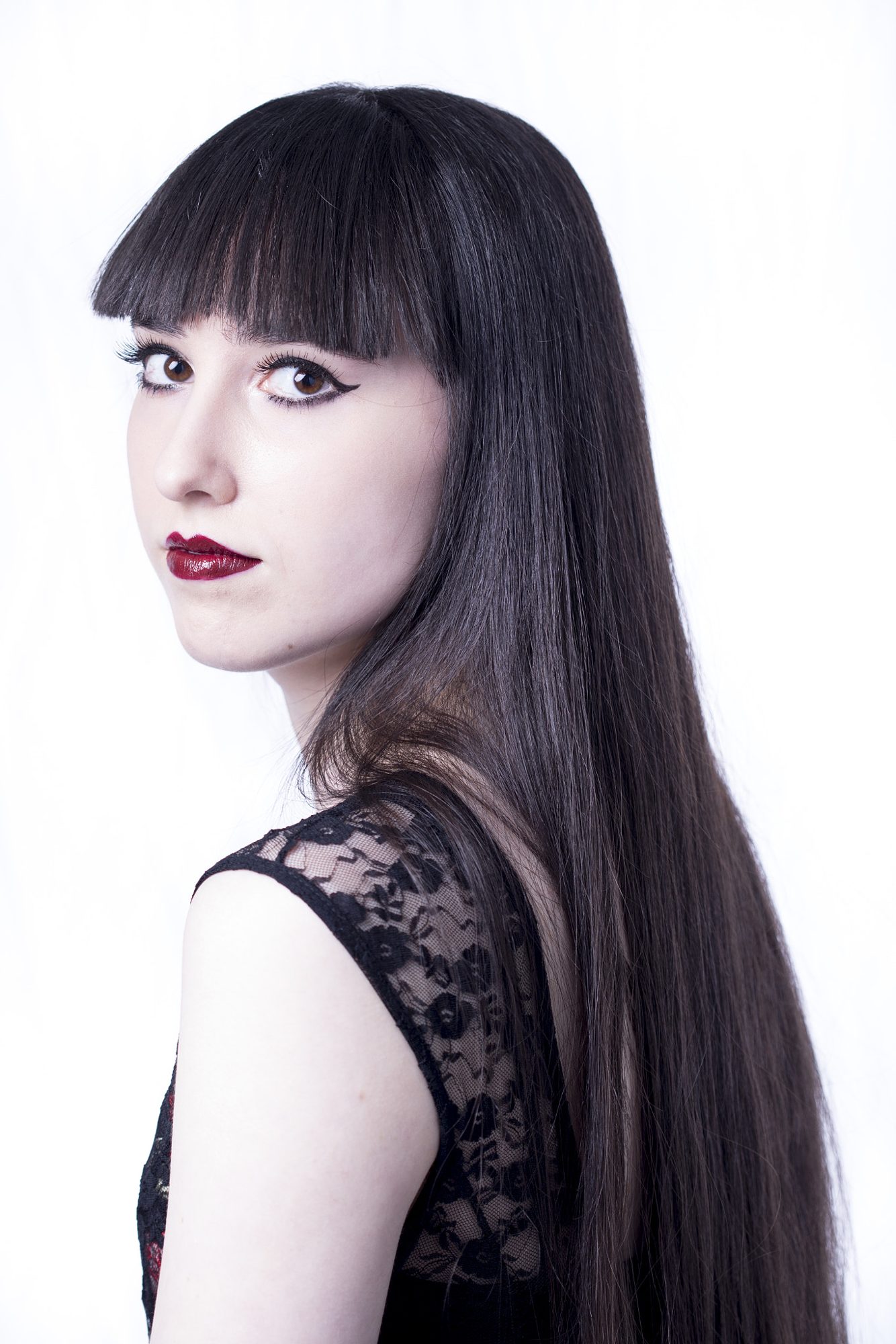 High-key portrait with black hair and dark lips