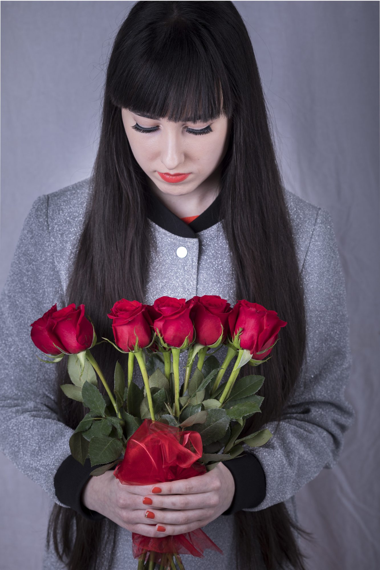 Woman holding a bouquet of red roses