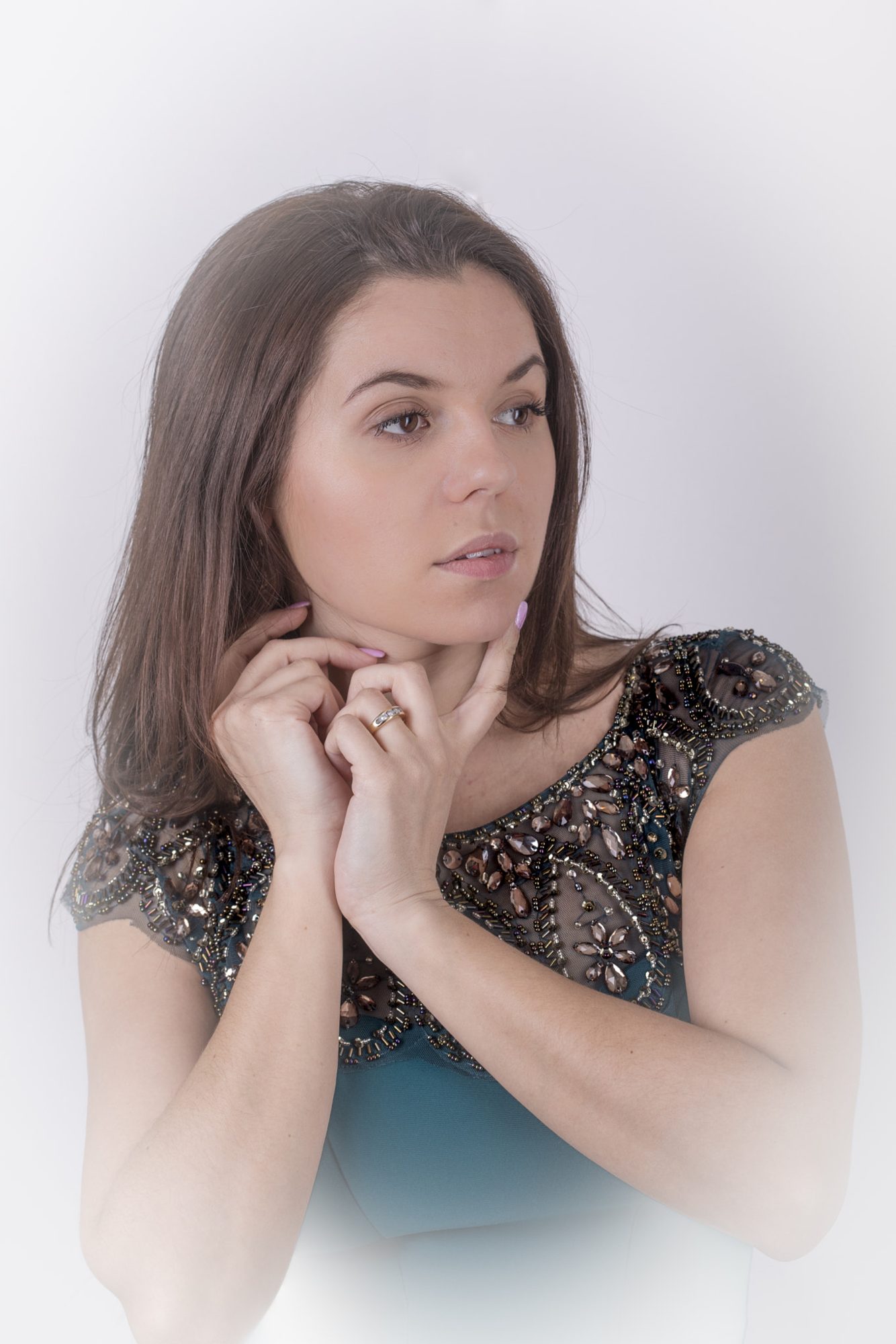 Studio portrait — direct gaze, teal dress
